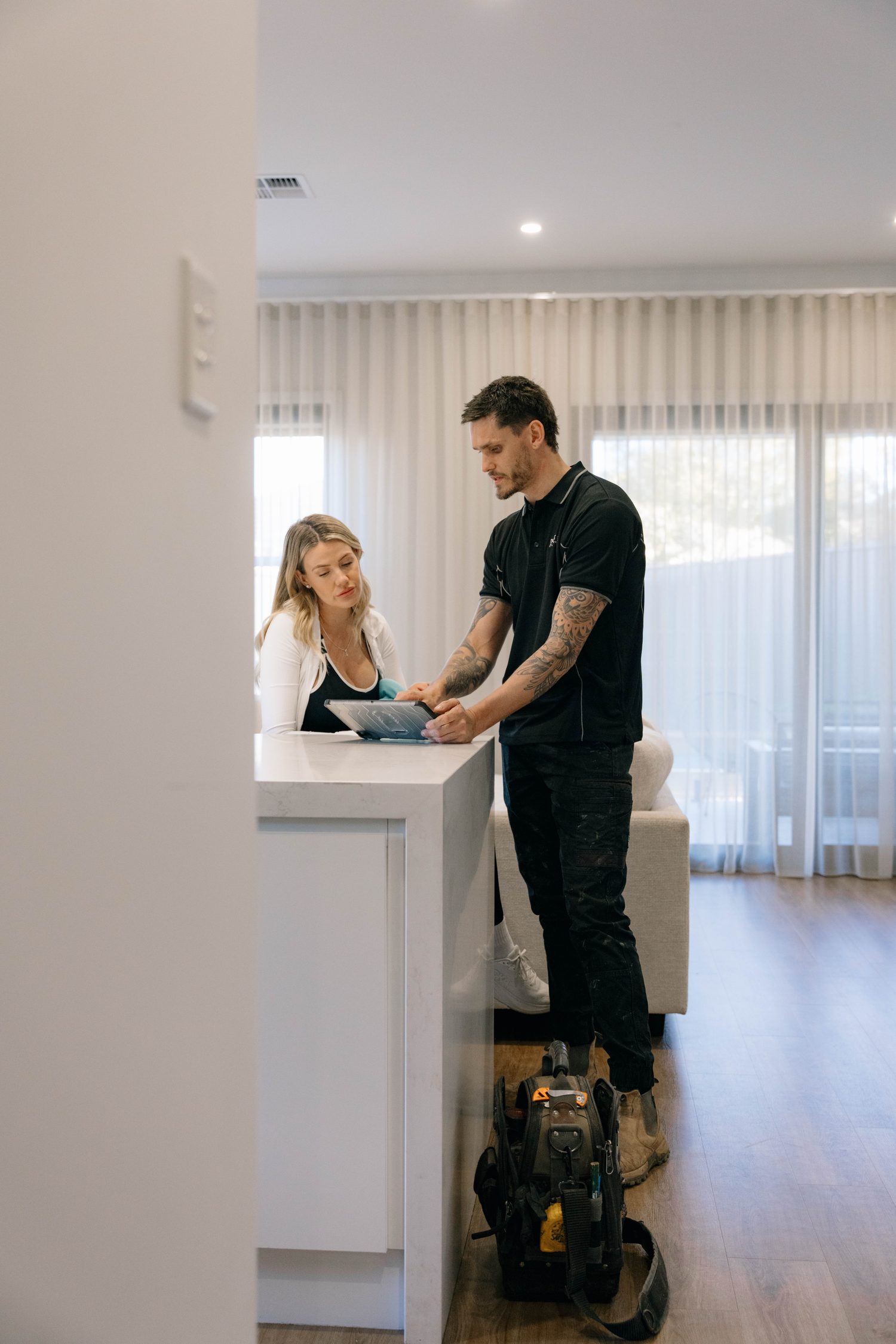 Walking a customer through the job at the kitchen bench